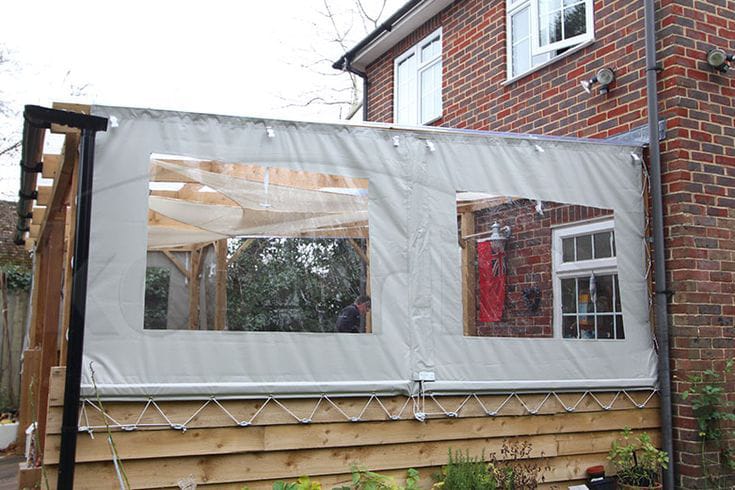 Light outdoor blind fitted to a raised deck