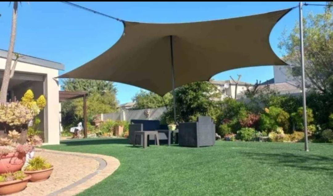 Brown shade sail over a garden seating area