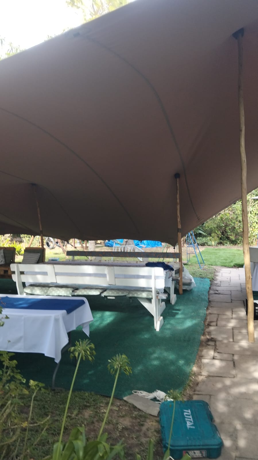 Stretch tent covering a garden seating area